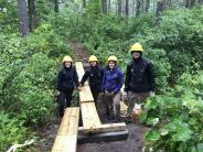 SCA NH Americorps constructing one of four bridges that they built at Doe Farm
