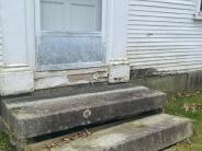 Decay in original wooden elements and deflection of the stone steps. Rotting woodwork will be replaced and the steps reset.