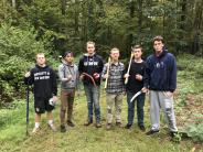 UNH Theta Chi fraternity brothers finish a morning of trail work at Doe Farm