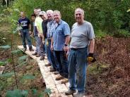 The Durham Rotary Club repairs the bog bridge near The Sweet Trail