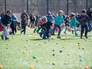 kids collecting eggs at our Annual Egg Hunt on the ORHS Turf field