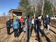 Twenty-two people gather to hear Dick Lord tell the history of the Thompson Forest and LRAC