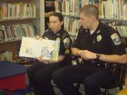 Sgt. Mone and Off. Glowacki read to pre-school students